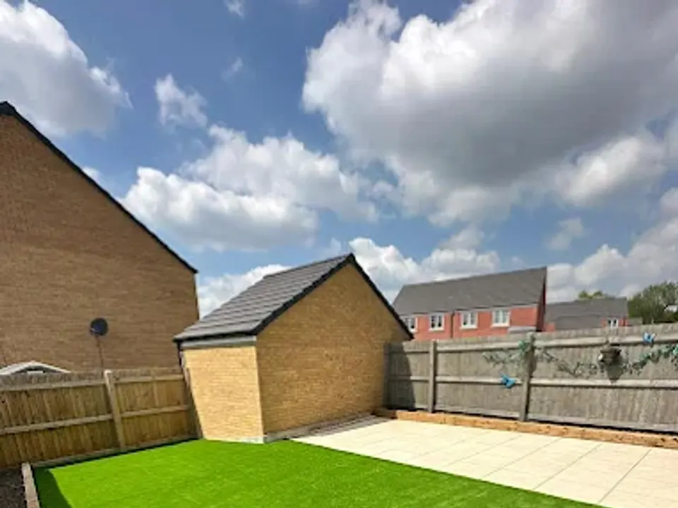 Artificial grass and porcelain paving in a new build garden
