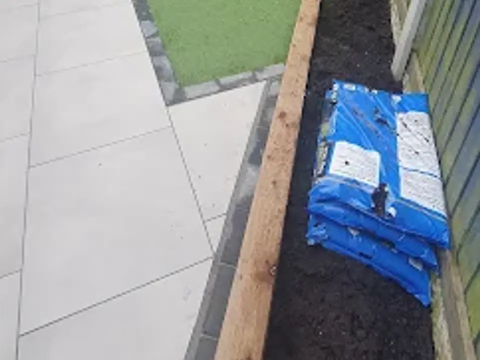 Artificial grass install with sleeper edging in progress