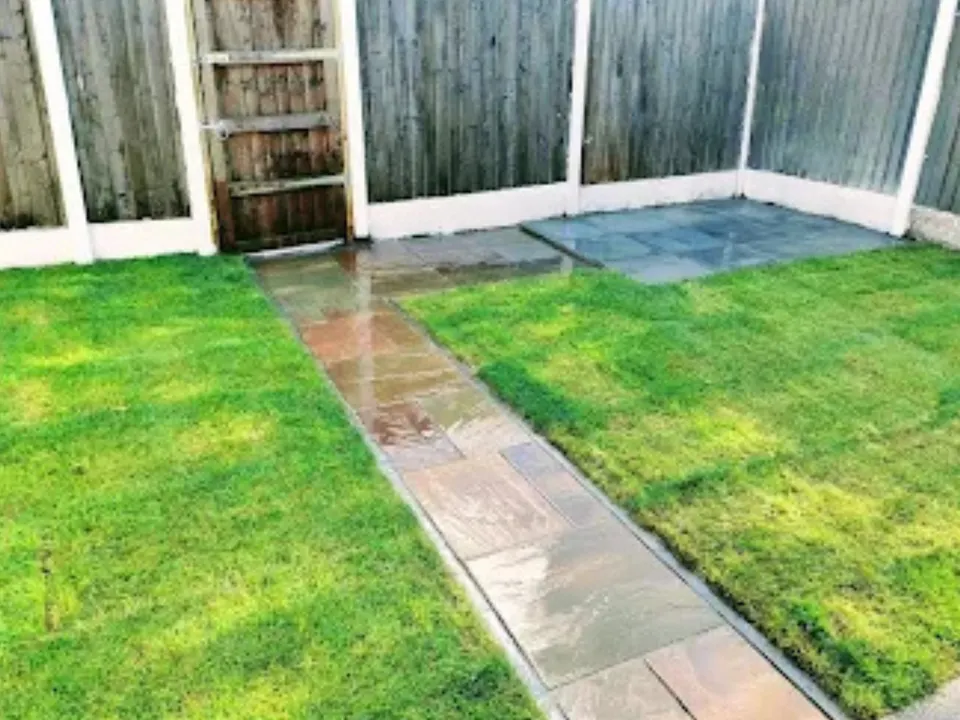 Fresh turf lawn with an Indian stone path