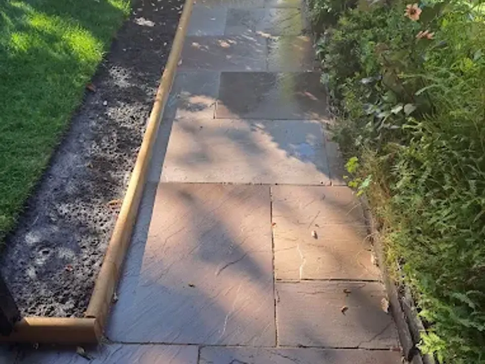 Flag path with timber edging beside a lawn