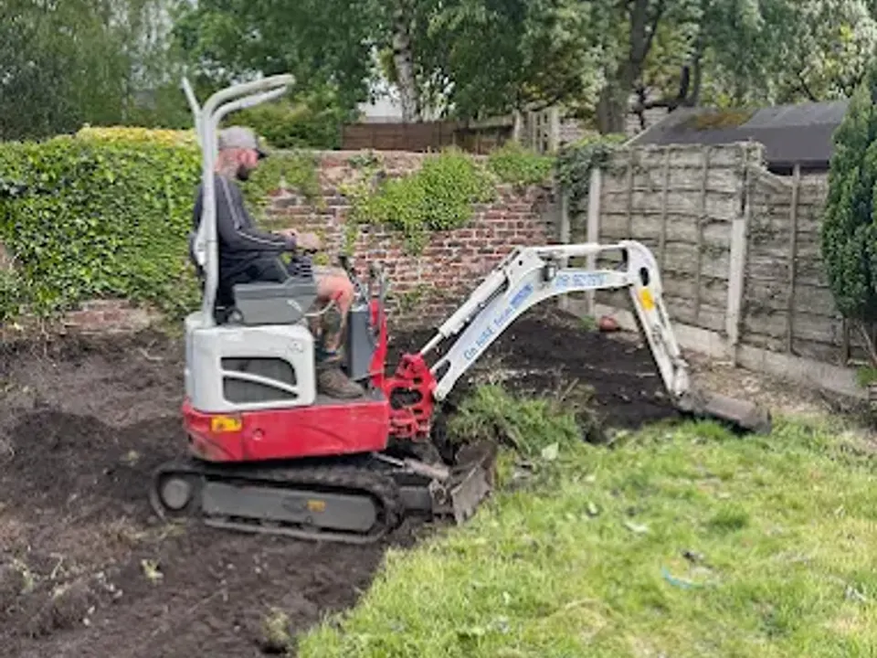 Garden clearance under way with a mini digger