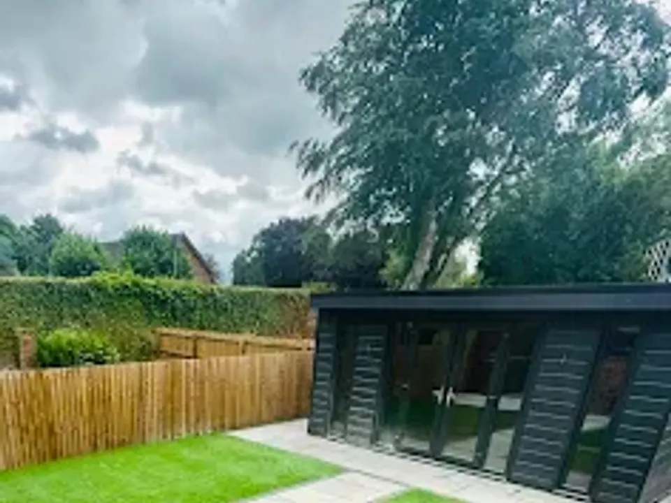 Garden room with artificial grass and porcelain stepping stones