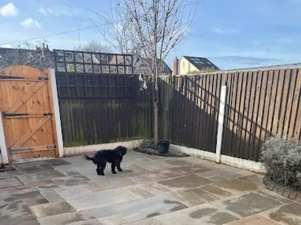 Indian stone patio with black fence and gate