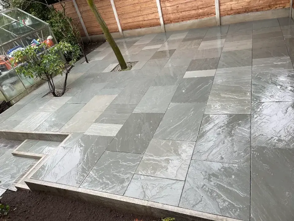Grey porcelain patio laid around a mature tree