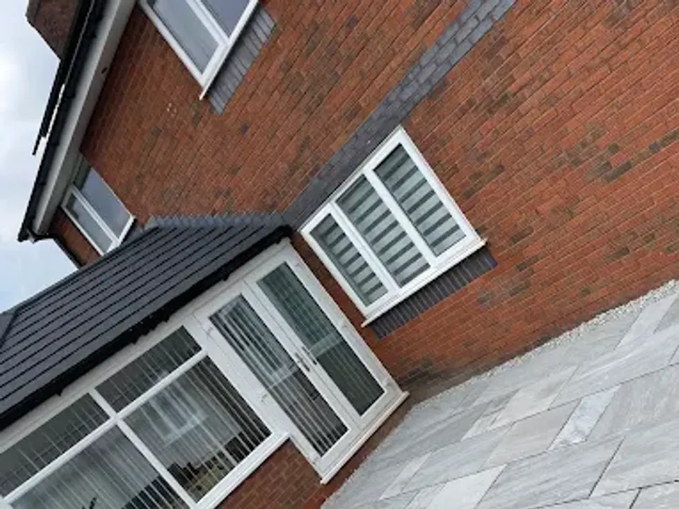 Porcelain patio laid diagonally by a bay window