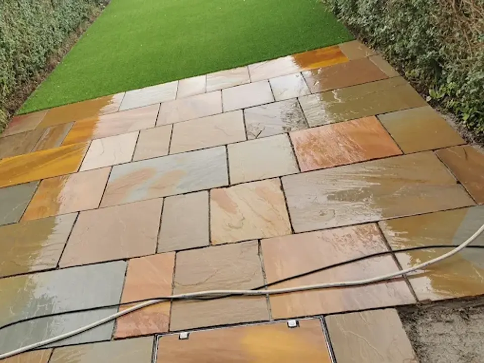 Indian sandstone path beside artificial grass